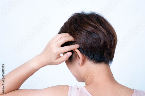 Portrait of an Asian short-haired woman turning her back on a white background