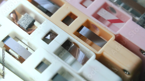 Abstract of Stack of analogue magnetic audio tape, group of colorful cassettes , Music archives on retro compact cassettes , retro background 