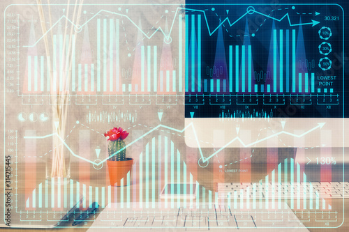 Financial graph colorful drawing and table with computer on background. Multi exposure. Concept of international markets. © peshkova