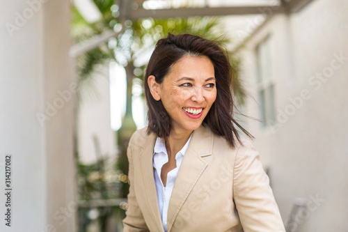 Portrait of a confident Asian businesswoman smiling.