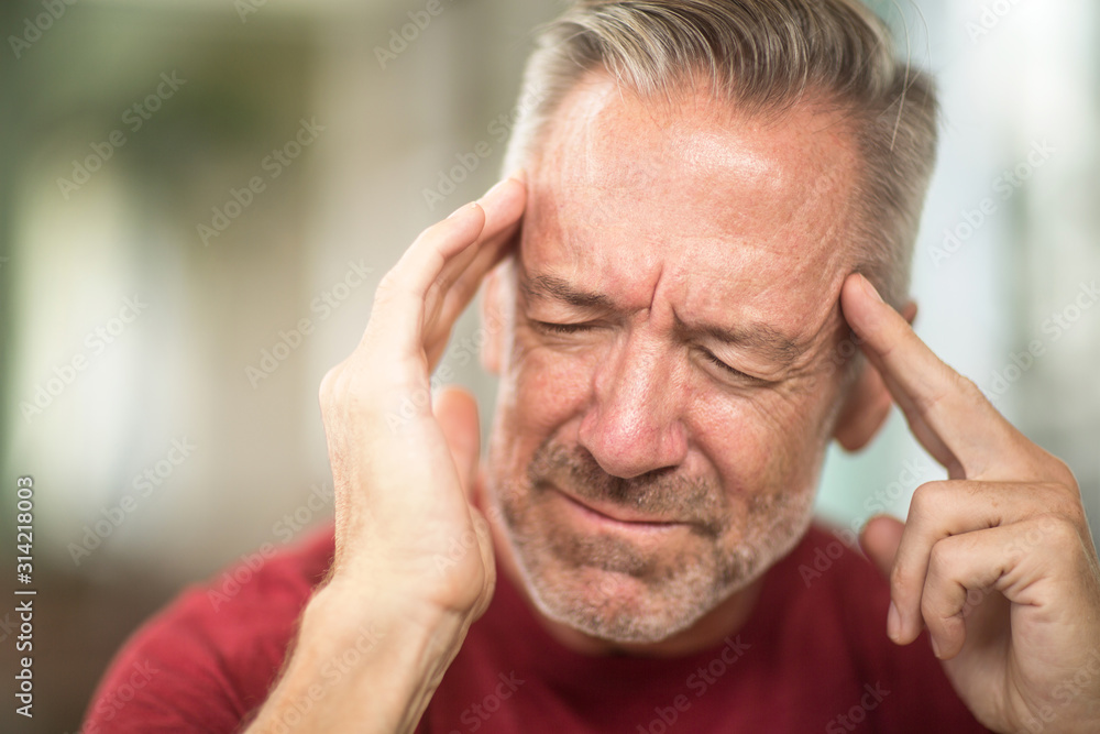 Mature man having a headache stock photo Mature man having a headache stock photo