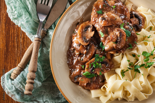 Delicious chicken marsala served with fettucine pasta photo