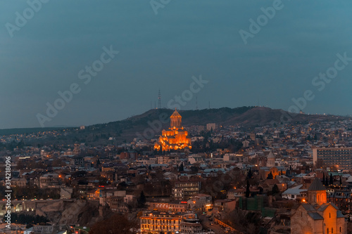 Tbilisi, Georgia, 15 December 2019 - view of the city and Sameba Cathedral at dusk
