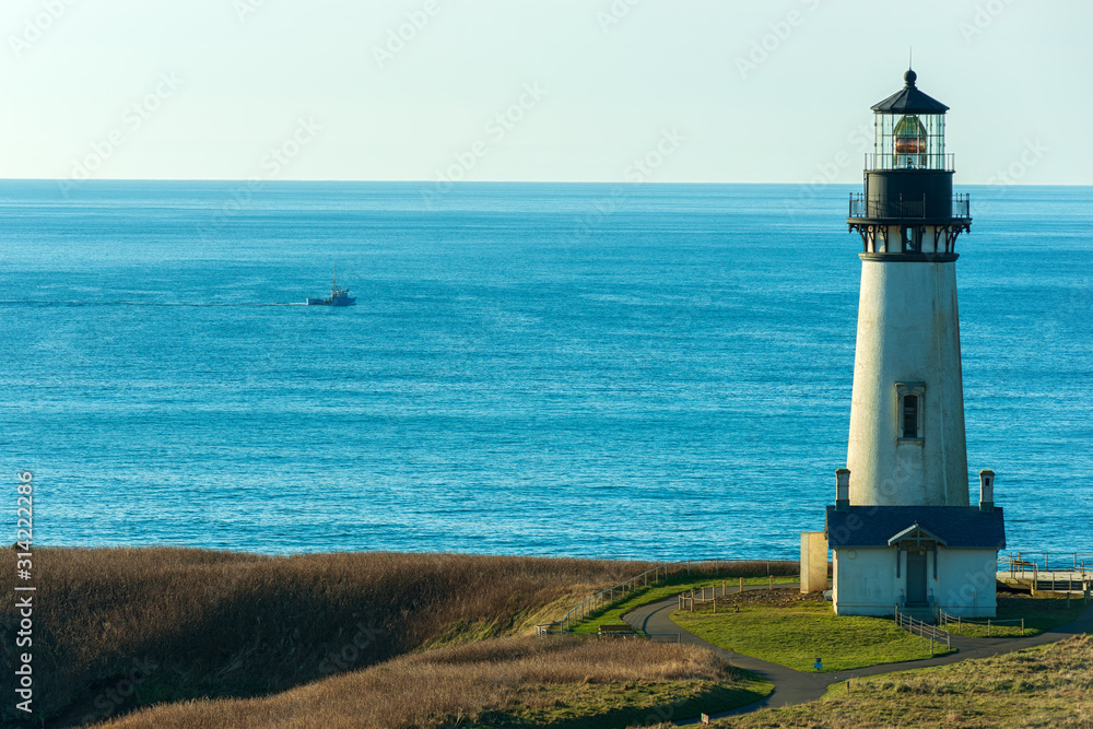 A Fishing Trawler Passes By the Yaquina Head Lighthouse, Newport, Oregon, USA