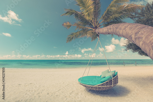Tropical beach background as summer landscape with beach swing or hammock and white sand and calm sea for beach banner. Perfect beach scene vacation and summer holiday concept. Vintage style process