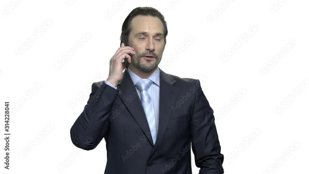 Confident caucasian businessman talking on cell phone. Handsome mature executive with beard isolated on white background. Confident caucasian businessman talking on cell phone. Handsome mature executive with beard isolated on white background.