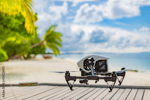 Drone flying above tropical beach scene, luxury resort or hotel advertising and film making.