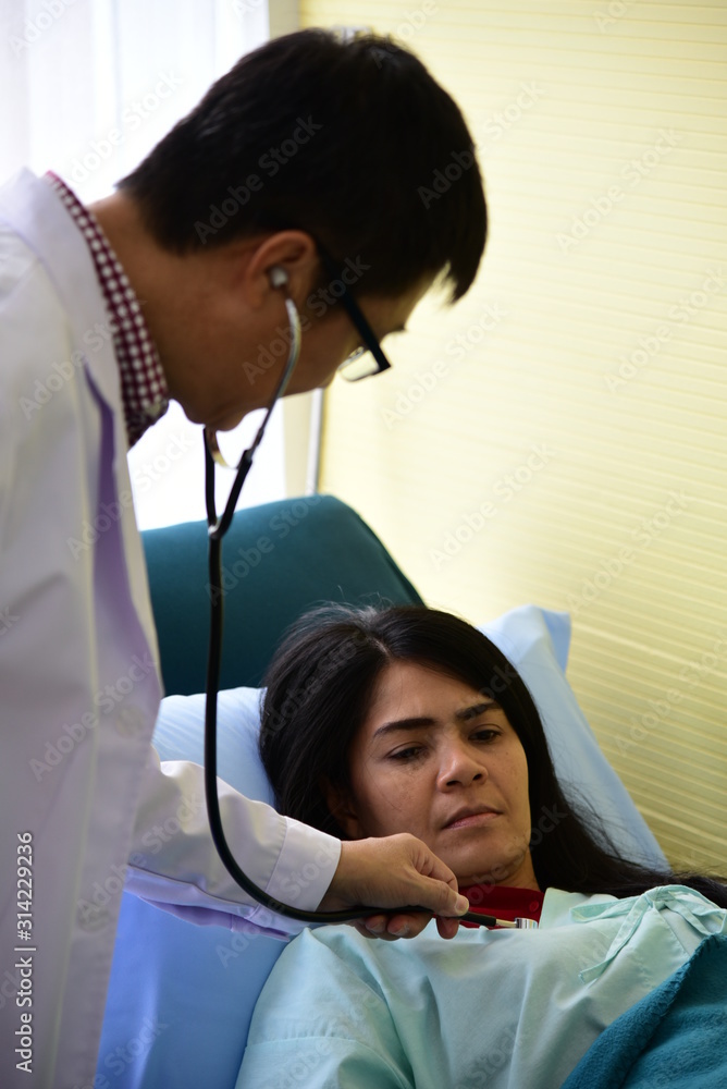Doctor is diagnosing the patient by stethoscope with care. Doctor is diagnosing the patient by stethoscope with care.