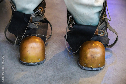 Close-up shoes of an old vintage three-bolt deep-sea diving suit. Suit for deep sea diving of the last century. The history of the study of the underwater world