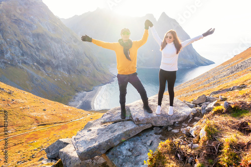 Happy couple of love are hiking on top of Mountain in Lofoten island, Norway © tonefotografia