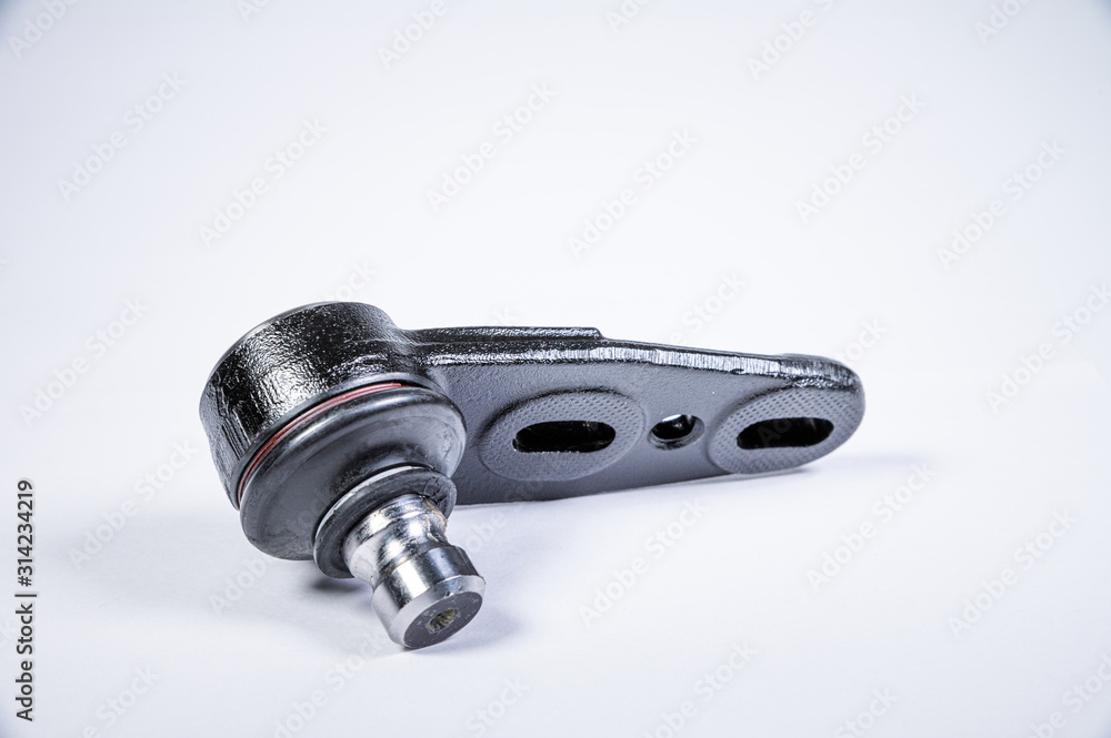 New spare parts spherical ball joints of a suspension bracket of a car on a gray background New spare parts spherical ball joints of a suspension bracket of a car on a gray background