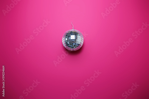 Saint Valentine's day card on pink background. Bright disco ball, colorful image, party theme.