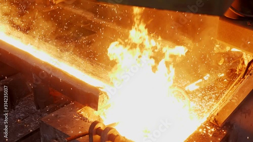 The liquid steel flows through the discharge chute. Steel production .