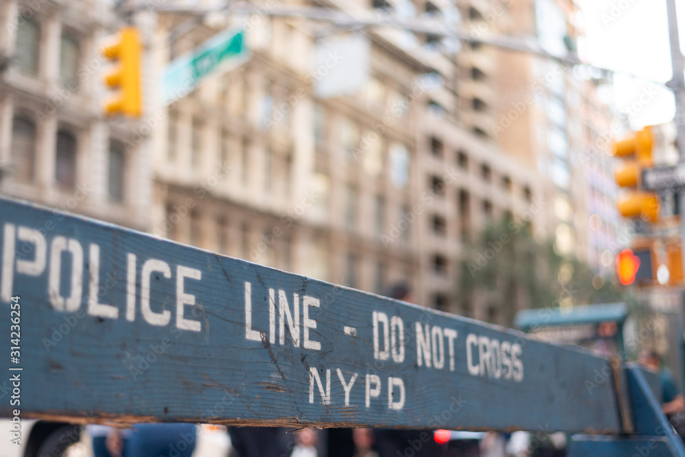 Obraz premium NYPD wooden barrier with a white 'Police line - Do not cross' text. Taken in Manhattan on September the 29th, 2019.