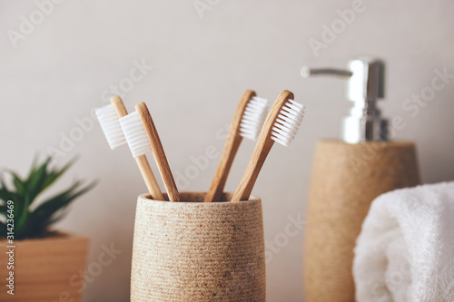 Close up of four bamboo toothbrushes in a cup photo