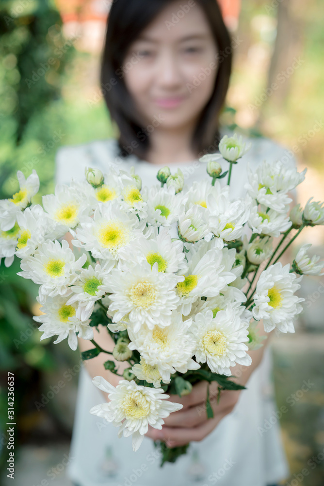 Woman holding white flowers Woman holding white flowers