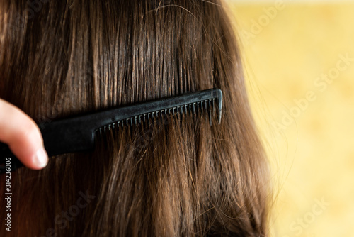  Close up woman combing hair