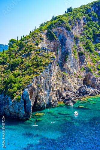 Agios Spiridon Beach with crystal clear azure water and white beach in beautiful landscape scenery - paradise coastline of Corfu island at Paleokastritsa  Ionian archipelago  Greece.