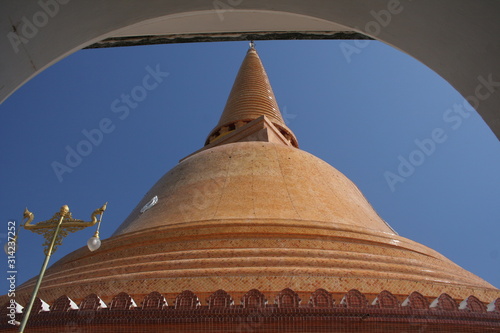 Light brown pagoda and blue sky   arch above stupa view. Pra Pathom Chedi is a big pagoda in Nakhon Pathom province  Thailand.