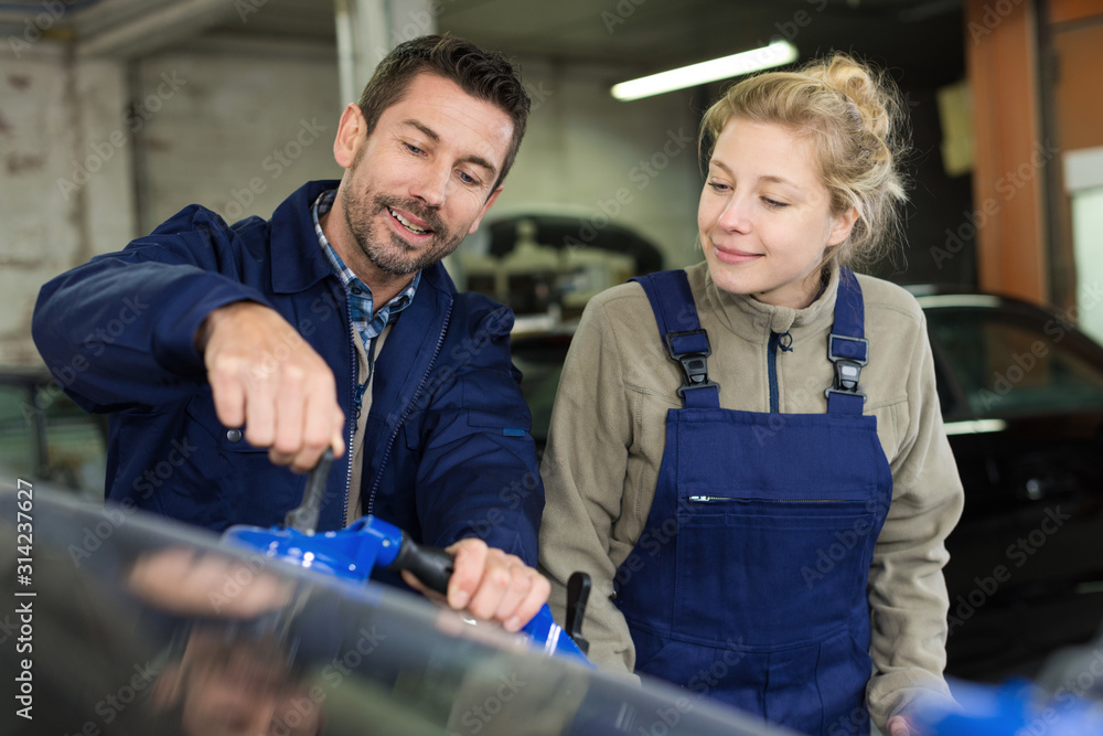 woman and man in workshop reparing woman and man in workshop reparing