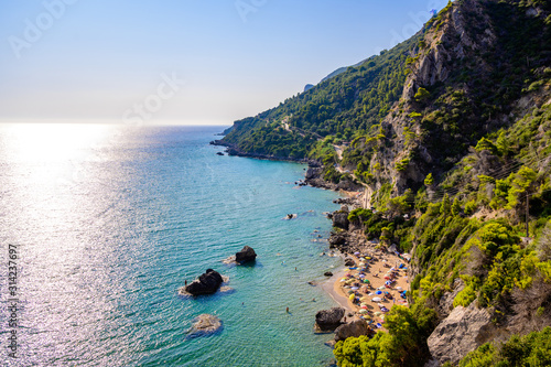 Fototapeta Naklejka Na Ścianę i Meble -  Mirtiotissa beach with crystal clear azure water and white beach in beautiful landscape scenery - paradise coastline of Corfu island close to Glyfada Beach, Ionian archipelago, Greece.