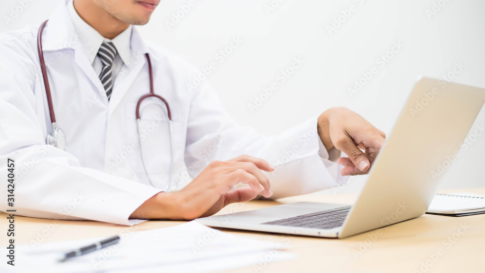 Young doctor working in his office stock photo