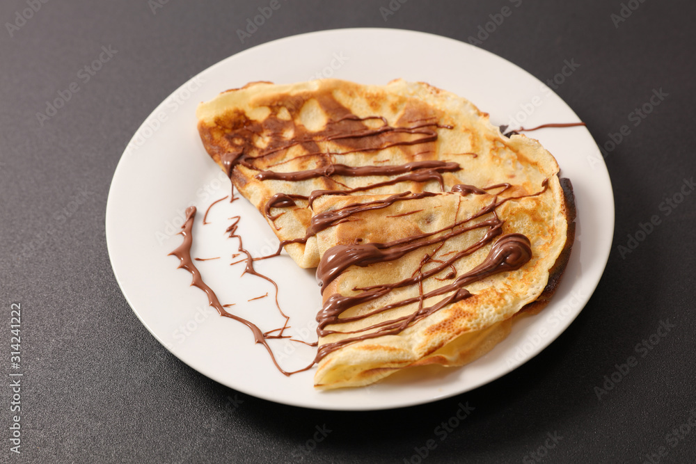 crepe with chocolate sauce in plate crepe with chocolate sauce in plate