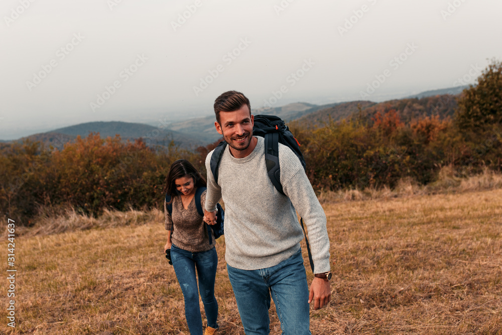 Young couple enjoying hiking together in nature.