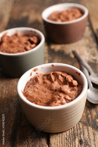 delicious creamy chocolate mousse on wood background