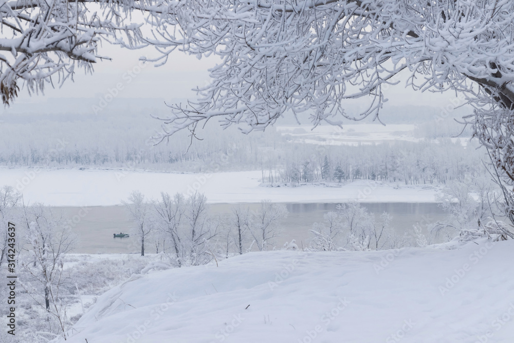 Fototapeta premium Winter landscape - view across the river to the opposite bank on