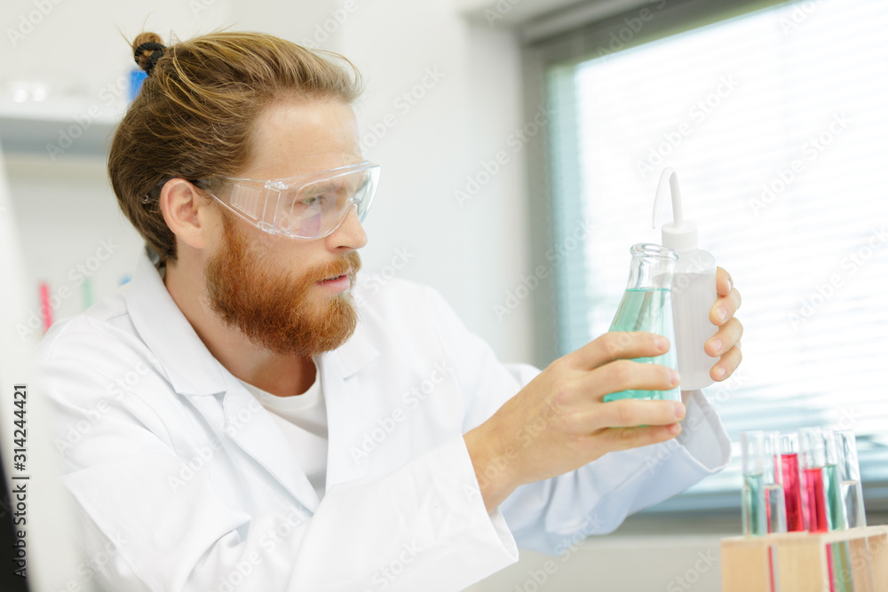 scientist chemist looking at chemicals scientist chemist looking at chemicals