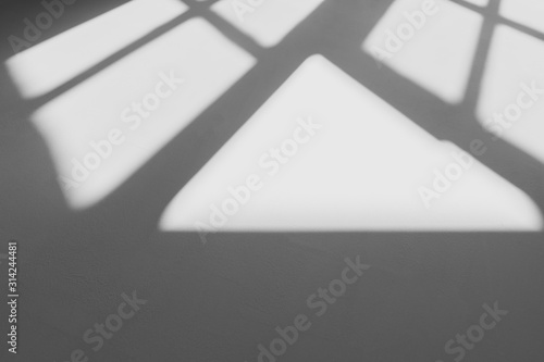 abstract shadow of the window in morning light on white wall texture background