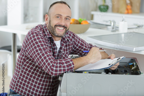 happy man fixing a washing machine