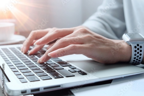 Asian woman is typing on keyboard of laptop or computer notebook for check electronic mail, preparation of presentation in meeting, get information for shopping online or operation of internet banking