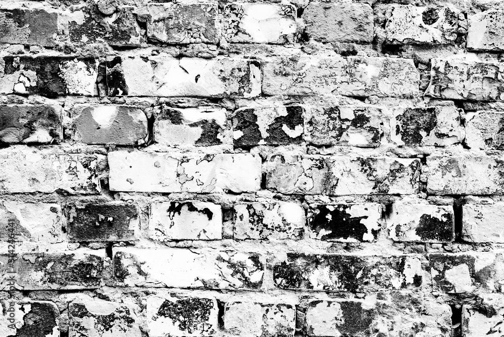 Texture of a brick wall with cracks and scratches which can be used as a background Texture of a brick wall with cracks and scratches which can be used as a background