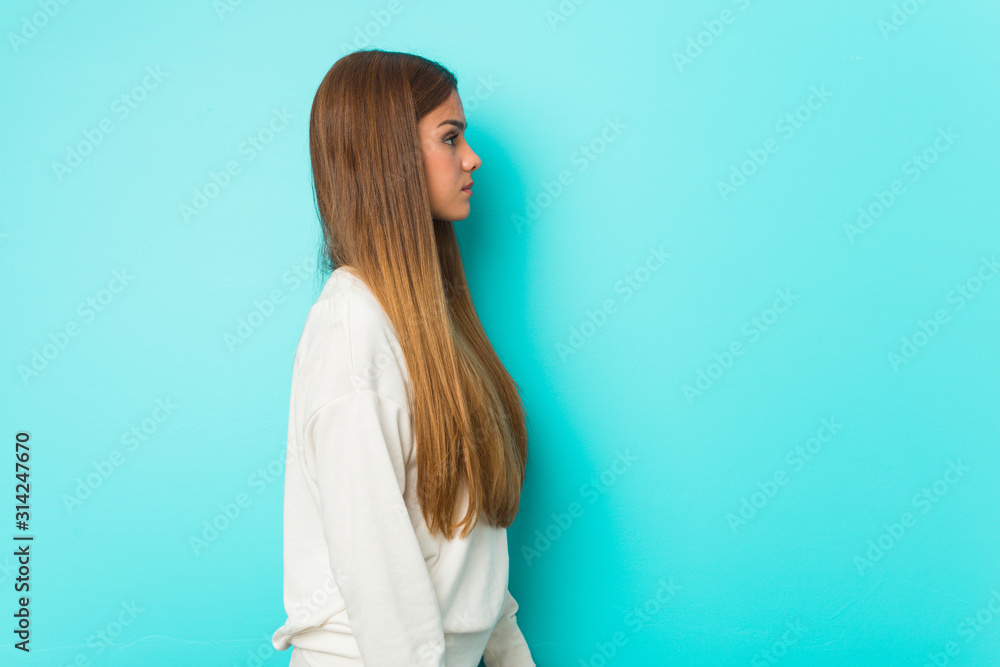 Young slim woman gazing left, sideways pose. Young slim woman gazing left, sideways pose.