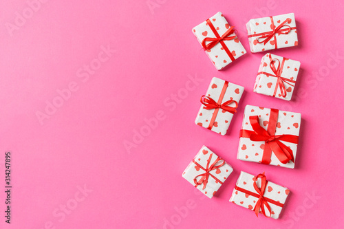 Top view of gift boxes with red hearts on colorful background. St Valentine's day concept with copy space