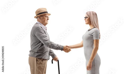 Elderly man shaking hands with a young woman