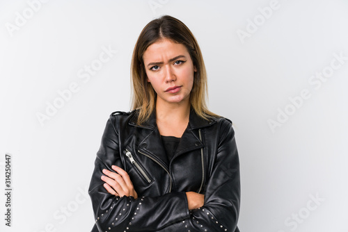Fotografija Young caucasian woman wearing a black leather jacket frowning face in displeasure, keeps arms folded