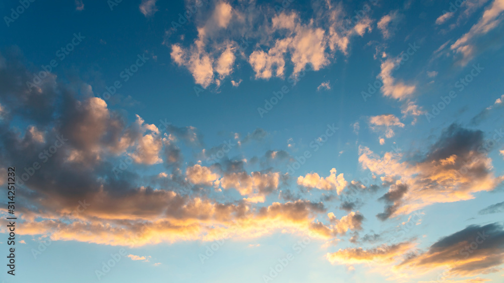 blue sky with white clouds beautifully lit by the sun as a background blue sky with white clouds beautifully lit by the sun as a background