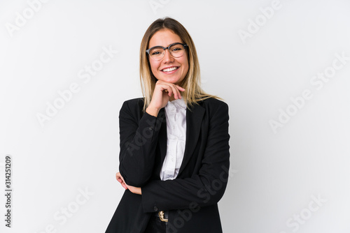 Obraz na plátně Young business caucasian woman smiling happy and confident, touching chin with hand