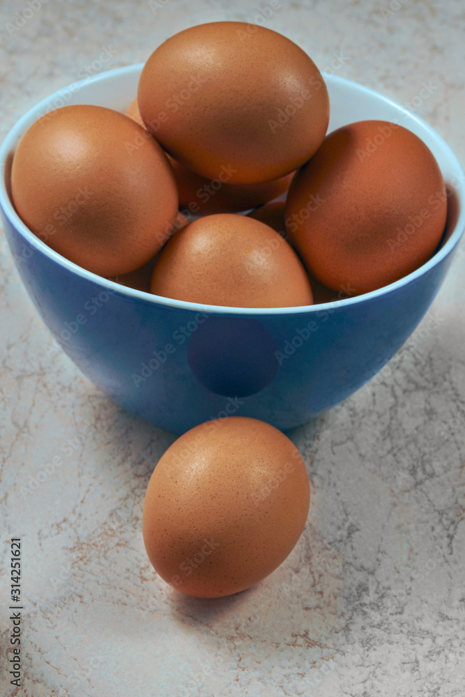 fresh chicken eggs in ceramic cups on a wooden background. Healthy eating concept fresh chicken eggs in ceramic cups on a wooden background. Healthy eating concept