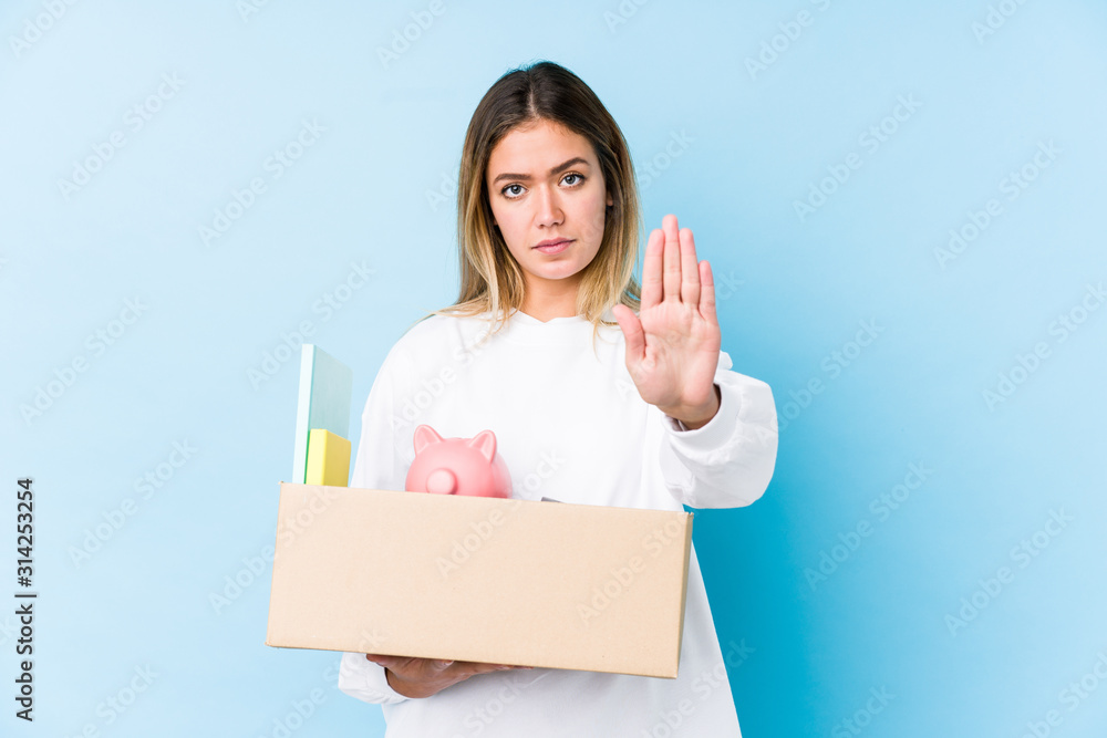Young caucasian woman moving home isolated standing with outstretched hand showing stop sign, preventing you. Young caucasian woman moving home isolated standing with outstretched hand showing stop sign, preventing you.