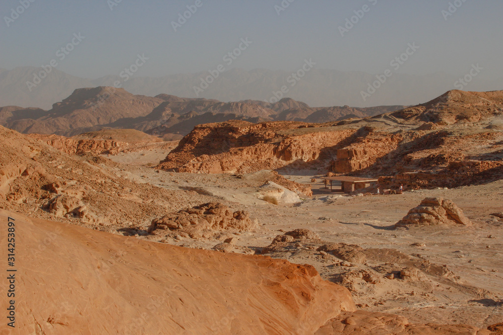Fototapeta premium The famous Timna National Park in the desert in southern Israel in the Eilat region. Sand cliffs, dry land, red sand in the form of pillars and mushrooms. Sights of Israel.