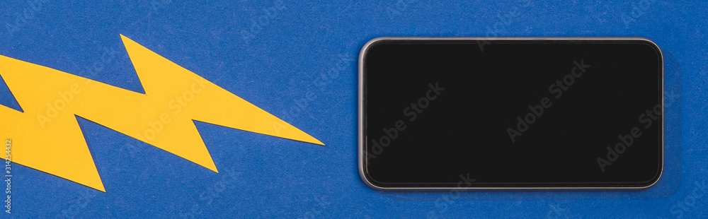 top view of lighting hitting smartphone on blue background, panoramic shot top view of lighting hitting smartphone on blue background, panoramic shot