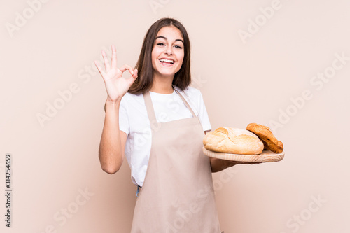 Canvastavla Young caucasian baker woman isolated cheerful and confident showing ok gesture