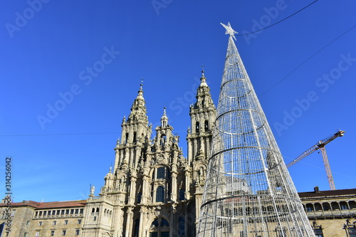 Cathedral from Praza do Obradoiro with Christmas led tree and blue sky. Santiago de Compostela, Spain.