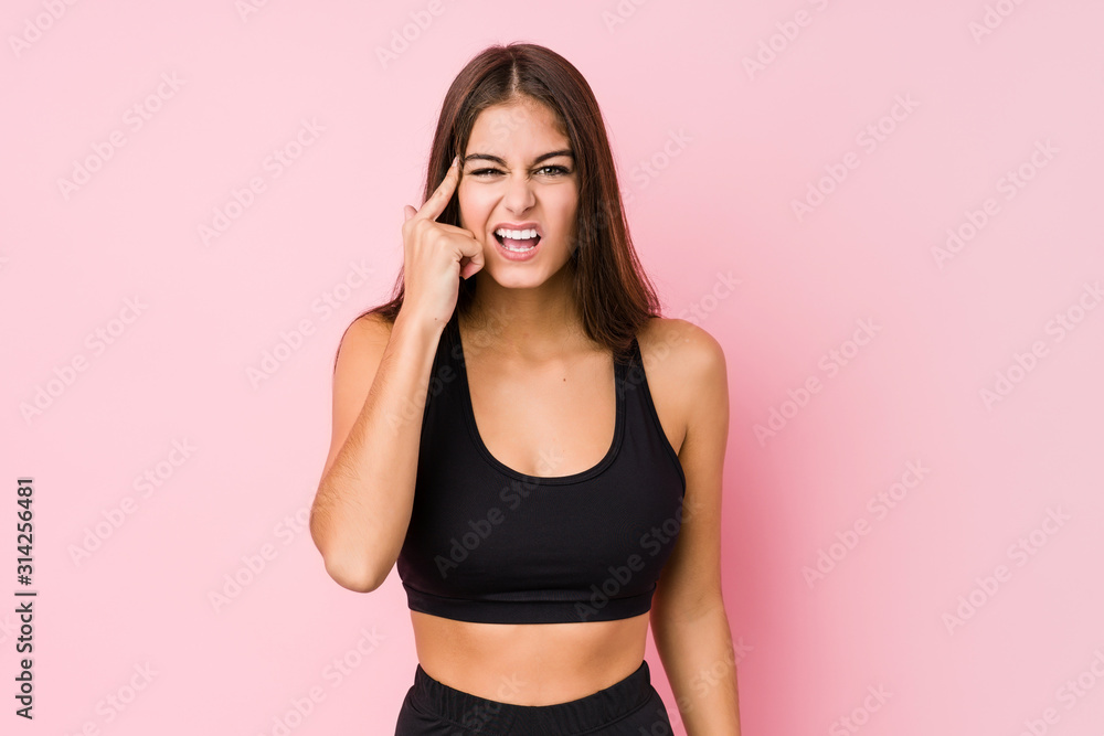 Young caucasian fitness woman doing sport isolated showing a disappointment gesture with forefinger. Young caucasian fitness woman doing sport isolated showing a disappointment gesture with forefinger.