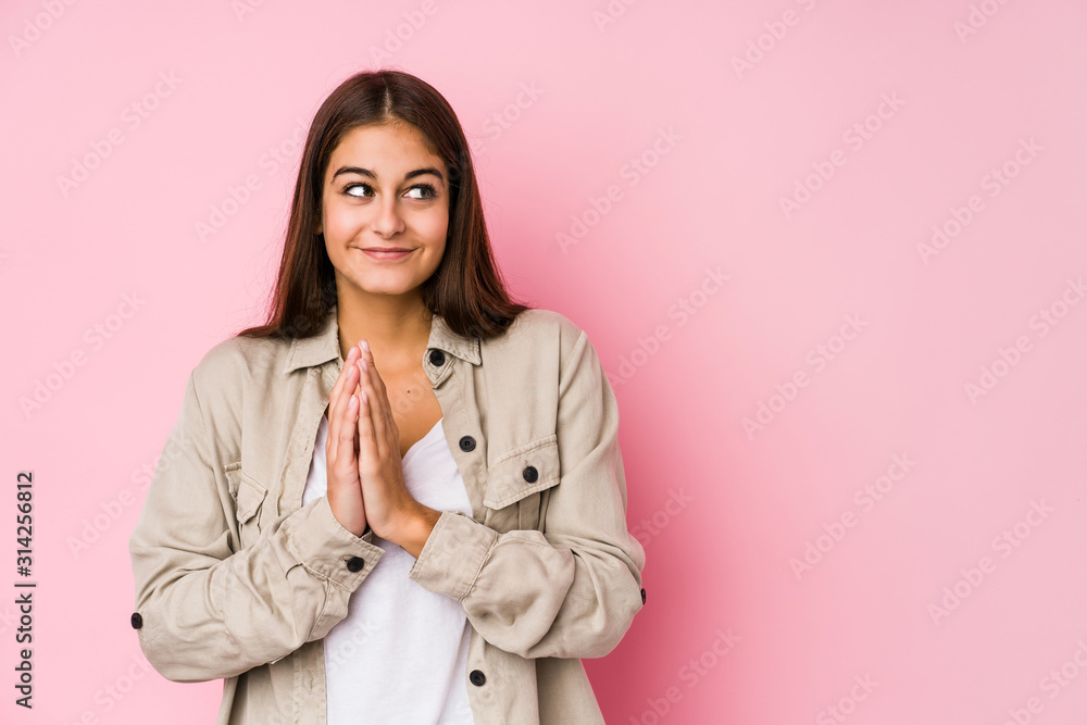 Young caucasian woman posing in a pink background making up plan in mind, setting up an idea.