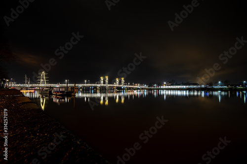 View over the IJssel river and city bridge in the evening